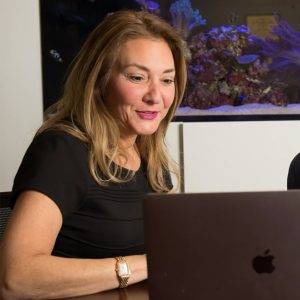 Michelle on Laptop Consulting with Leaders on Adaptability